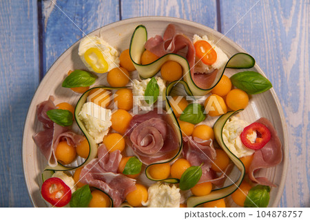 RECIPE FOR MELON, MOZARELLA, BASIL AND CURED HAM SALAD, CUCUMBER SLICE, ORANGE VINAIGRETTE RECIPE FOR MELON, MOZARELLA, BASIL AND CURED HAM SALAD, CUCUMBER SLICE, ORANGE VINAIGRETTE 104878757