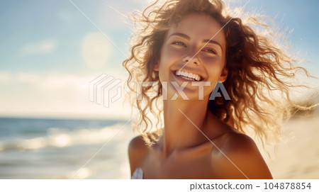 Portrait of a beautiful girl with long loose hair on the beach in front of the sea Portrait of a beautiful girl with long loose hair on the beach in front of the sea 104878854