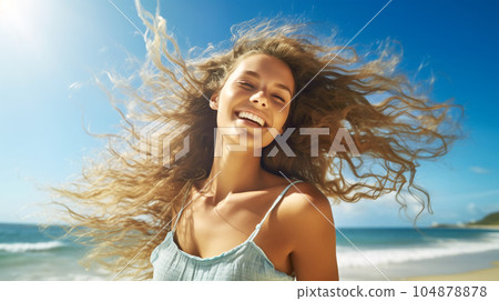Portrait of a beautiful girl with long loose hair on the beach in front of the sea 104878878