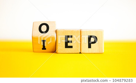 IEP or OEP symbol. Concept words IEP initial enrollment period OEP open enrollment period. Beautiful yellow table white background. Medical initial or open enrollment period concept. Copy space. 104879283