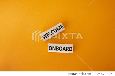 Welcome onboard symbol. Concept words Welcome onboard on wooden blocks. Beautiful orange background. Business and Welcome onboard concept. Copy space. 104879296