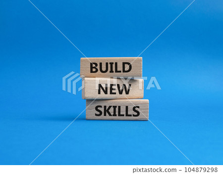 Build New skills symbol. Concept word Build New skills on wooden blocks. Beautiful blue background. Business and Build New skills concept. Copy space Build New skills symbol. Concept word Build New skills on wooden blocks. Beautiful blue background. Business and Build New skills concept. Copy space 104879298