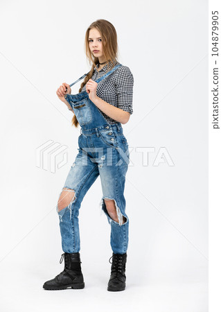 Young girl poses for a photo while standing on a white background Young girl poses for a photo while standing on a white background 104879905