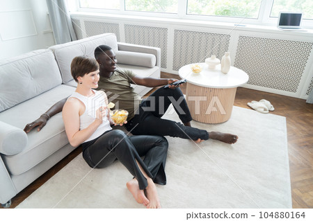 Young man watching TV 104880164