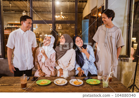 a group of Muslim friends chatting during iftar at an cafe 104880340