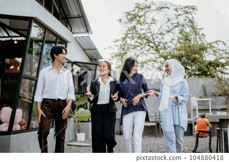 Group of cheerful young businesspeople chatting about business in a coworking space Group of cheerful young businesspeople chatting about business in a coworking space 104880418