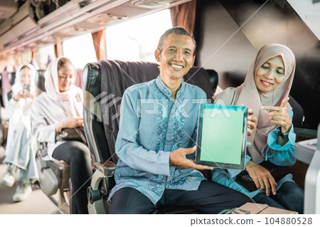 mature muslim couple using showing blank tablet screen mature muslim couple using showing blank tablet screen 104880528
