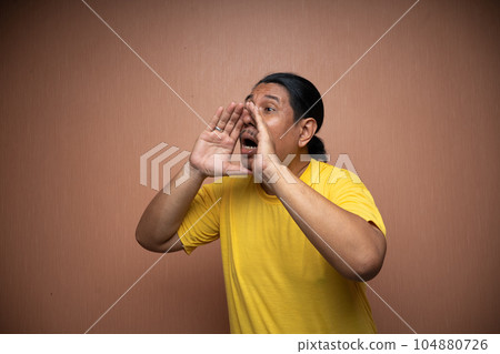 old asian man with shouting gesture in plain background 104880726