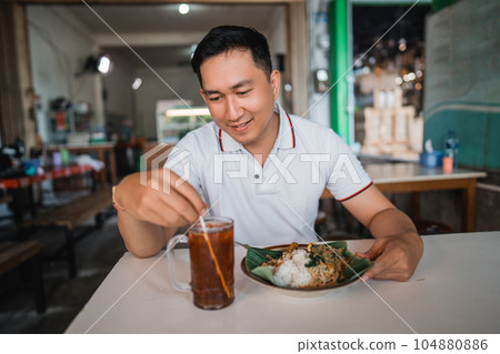 handsome man stall customer receiving drinks and food during lunch handsome man stall customer receiving drinks and food during lunch 104880886