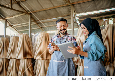 two male entrepreneurs and a veiled woman using tablets together two male entrepreneurs and a veiled woman using tablets together 104880906