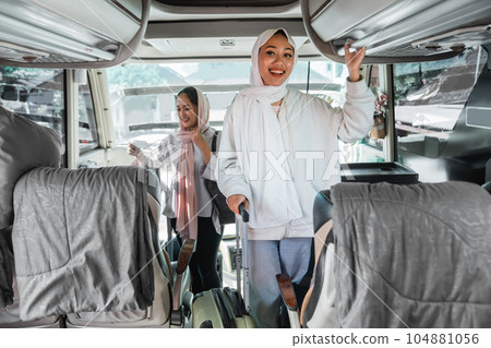 woman put her bag on a bus shelf bagage while traveling woman put her bag on a bus shelf bagage while traveling 104881056