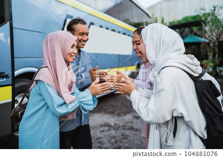 family taking parent to the bus station and shake hand goodbye family taking parent to the bus station and shake hand goodbye 104881076