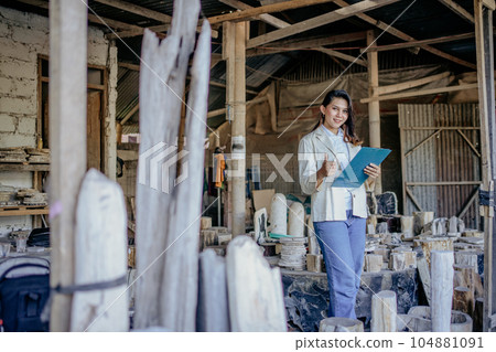 stone craft business owner woman giving thumbs up and holding clipboard stone craft business owner woman giving thumbs up and holding clipboard 104881091
