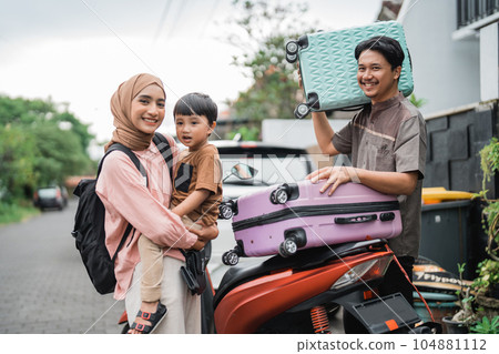muslim family going with motorbike together during eid mubarak 104881112
