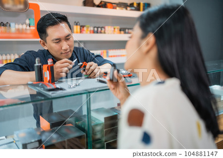 female customer vaping inside the vape store female customer vaping inside the vape store 104881147