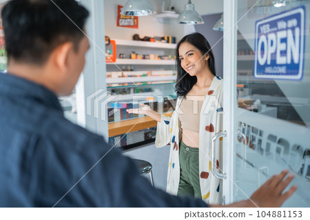 female vape seller welcoming the male customer female vape seller welcoming the male customer 104881153