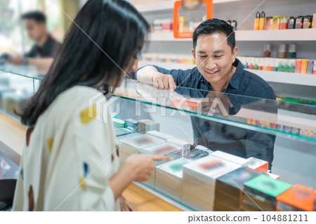 female customer pointing on the vape mod female customer pointing on the vape mod 104881211