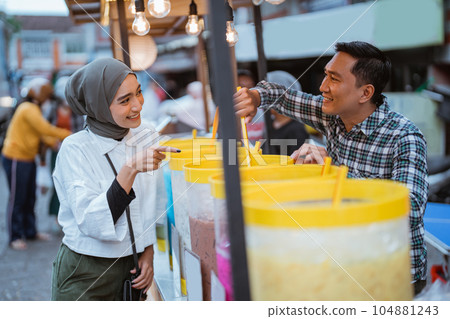 man sells colorful drink and juice in a jar man sells colorful drink and juice in a jar 104881243
