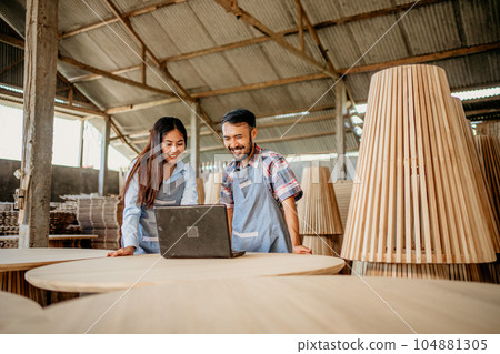 Asian business couple using a laptop computer together Asian business couple using a laptop computer together 104881305