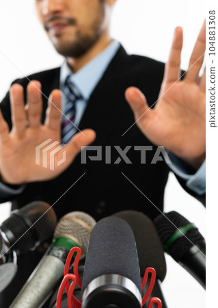 several kind of microphone pointed at an adult man several kind of microphone pointed at an adult man 104881308