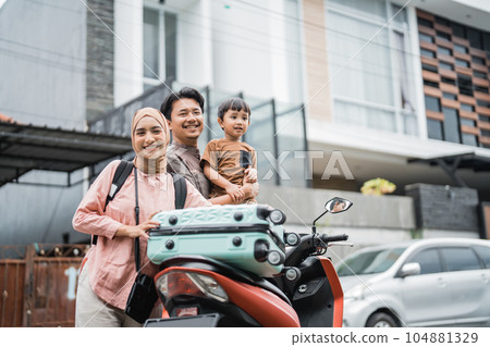 muslim family going with motorbike together during eid mubarak muslim family going with motorbike together during eid mubarak 104881329