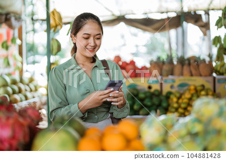beautiful customer looking at the phone beautiful customer looking at the phone 104881428