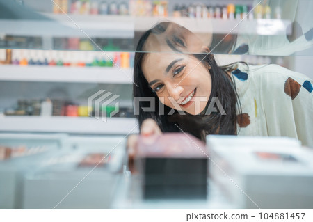 beautiful seller smiling while taking the vape mod beautiful seller smiling while taking the vape mod 104881457