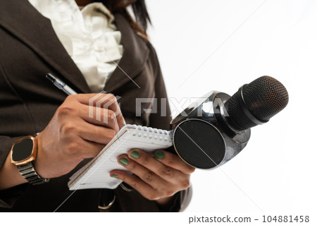 the hand of a journalist writing on a notebook the hand of a journalist writing on a notebook 104881458