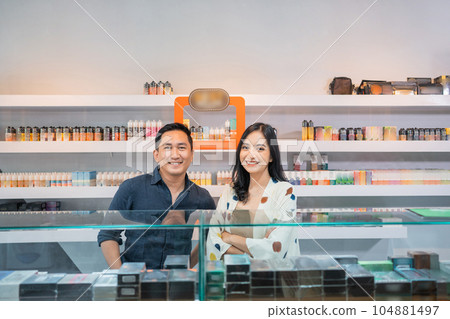 couple of vape shopkeeper standing with smile couple of vape shopkeeper standing with smile 104881497