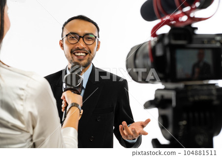 an adult men in blue shirt talking to the camera an adult men in blue shirt talking to the camera 104881511