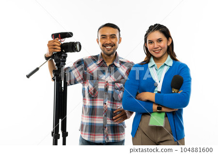 a beautiful reporter standing next to the cameraman a beautiful reporter standing next to the cameraman 104881600