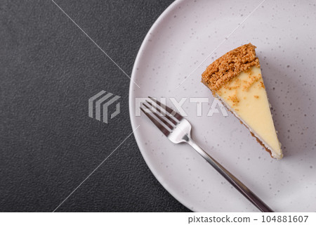 Delicious sweet cheesecake cake on textured concrete background Delicious sweet cheesecake cake on textured concrete background 104881607