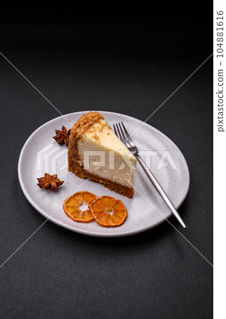 Delicious sweet cheesecake cake on textured concrete background Delicious sweet cheesecake cake on textured concrete background 104881616