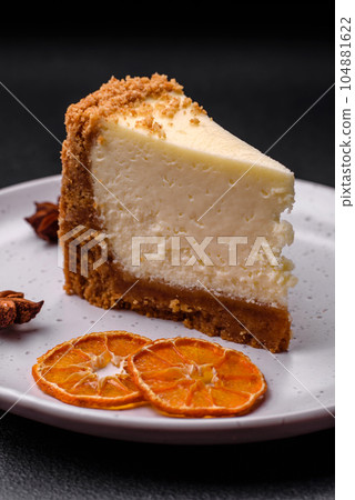Delicious sweet cheesecake cake on textured concrete background Delicious sweet cheesecake cake on textured concrete background 104881622