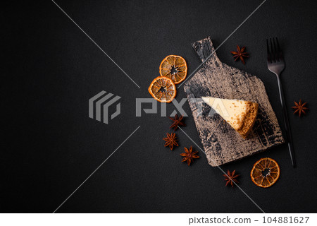 Delicious sweet cheesecake cake on textured concrete background Delicious sweet cheesecake cake on textured concrete background 104881627