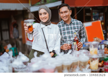 girl in a veil and a man sells mix fruit beverage and juice girl in a veil and a man sells mix fruit beverage and juice 104881628