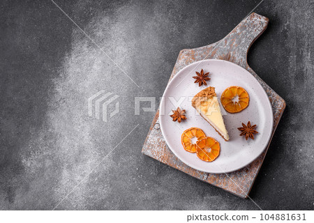 Delicious sweet cheesecake cake on textured concrete background Delicious sweet cheesecake cake on textured concrete background 104881631