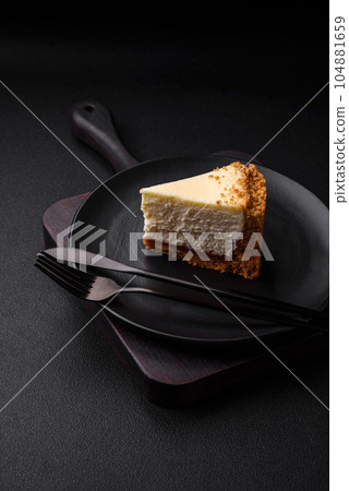 Delicious sweet cheesecake cake on textured concrete background Delicious sweet cheesecake cake on textured concrete background 104881659