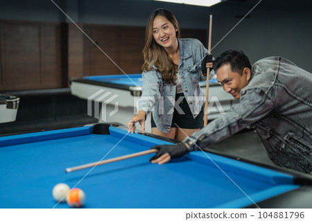 male pool player poking the object ball male pool player poking the object ball 104881796