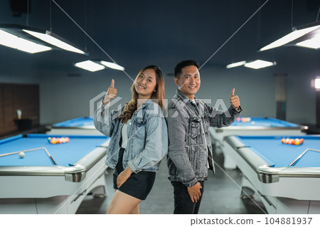 couple of billiard players standing back to back with thumb up 104881937