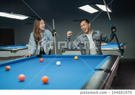 female player paying attention to the male player that clenched his arm female player paying attention to the male player that clenched his arm 104881979