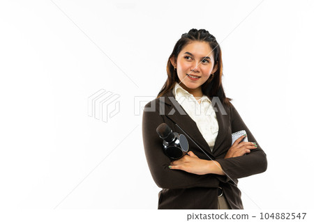 a female journalist standing with hand crossed and smiling a female journalist standing with hand crossed and smiling 104882547