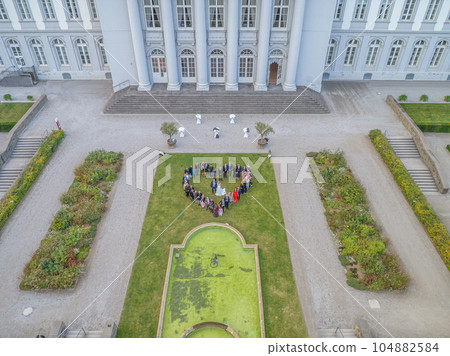 Wedding guests lined up in the shape of heart with bride and groom marriage people 104882584