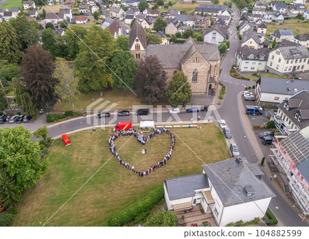 Wedding guests lined up in the shape of heart with bride and groom marriage people 104882599
