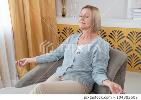 Blond senior woman relaxing 104882602