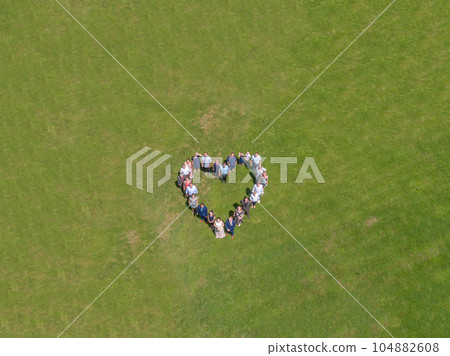 Wedding guests lined up in the shape of heart with bride and groom marriage people 104882608