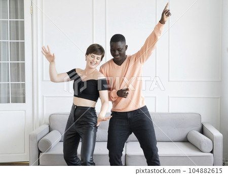 Couple of young man and woman dancing at home 104882615