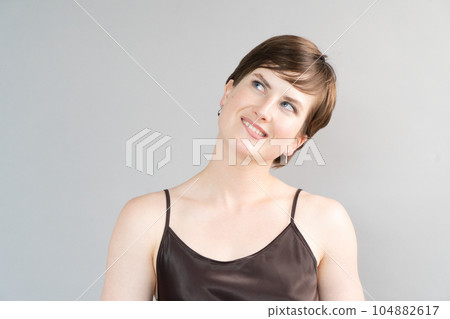 Happy young girl isolated over gray background 104882617