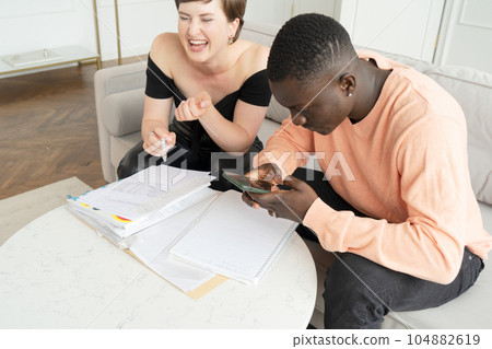 Couple of young people doing house paperwork 104882619