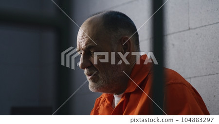Criminal sits on bed and dreams about freedom Criminal sits on bed and dreams about freedom 104883297